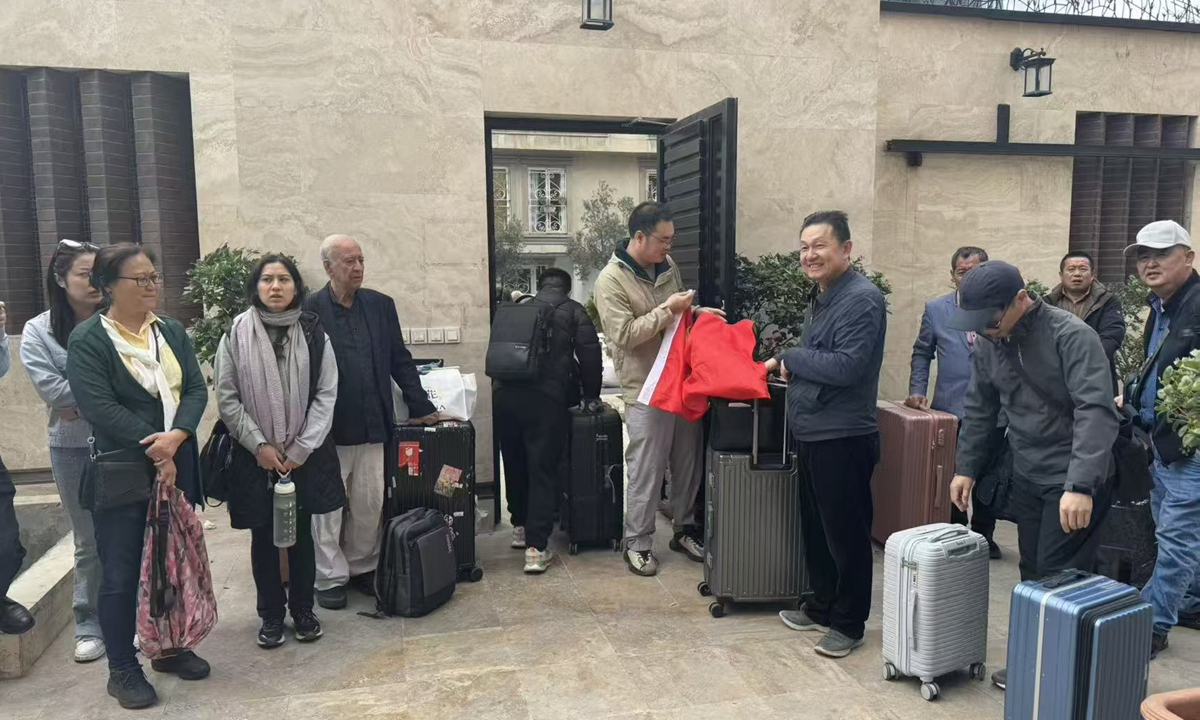 Chinese citizens in Tehran gathering on March 2, 2026, awaiting evacuation as war breaks out.